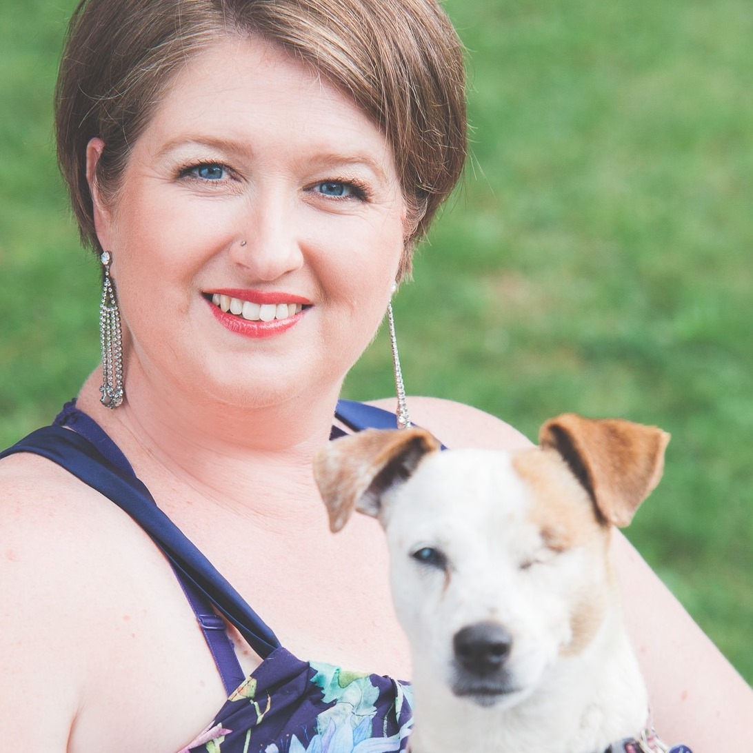 Smiling female entrepreneur cassie's workshop with jack russel